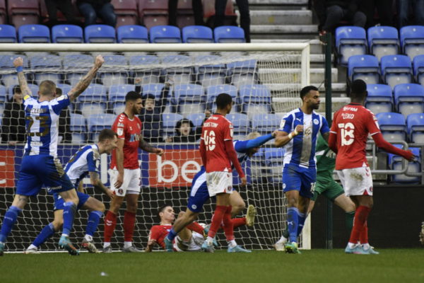 Wigan players celebrate against Charlton as substitute Stephen Humphrys completes their comeback.