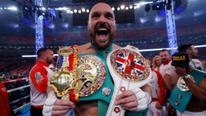Tyson Fury celebrates with his multiple world championships.